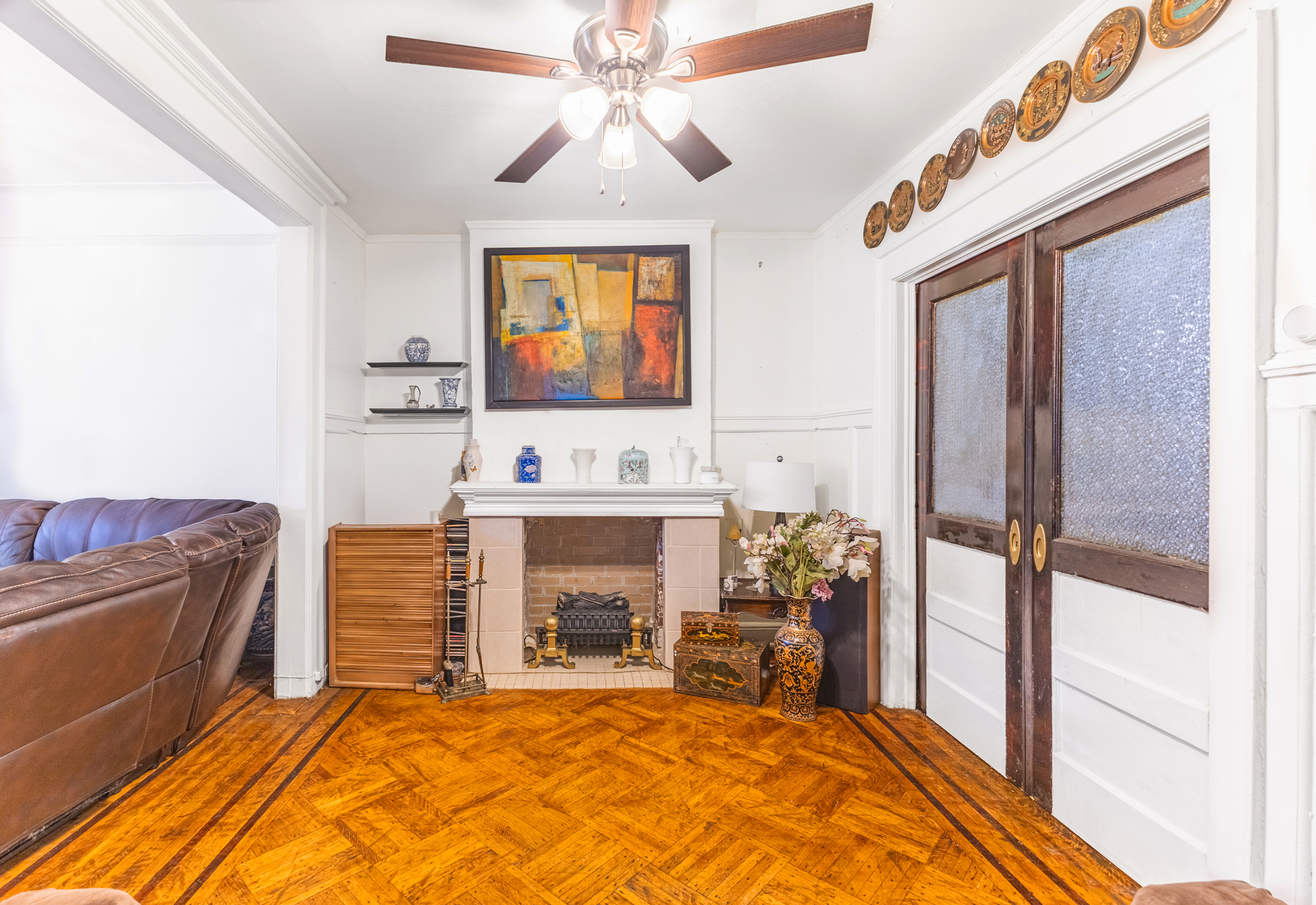 201 Maple Street Brooklyn, NY 11225 - Photo 6 of 21 a living room with furniture a fireplace and a flat screen tv