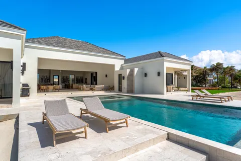 a view of a house with swimming pool and a yard