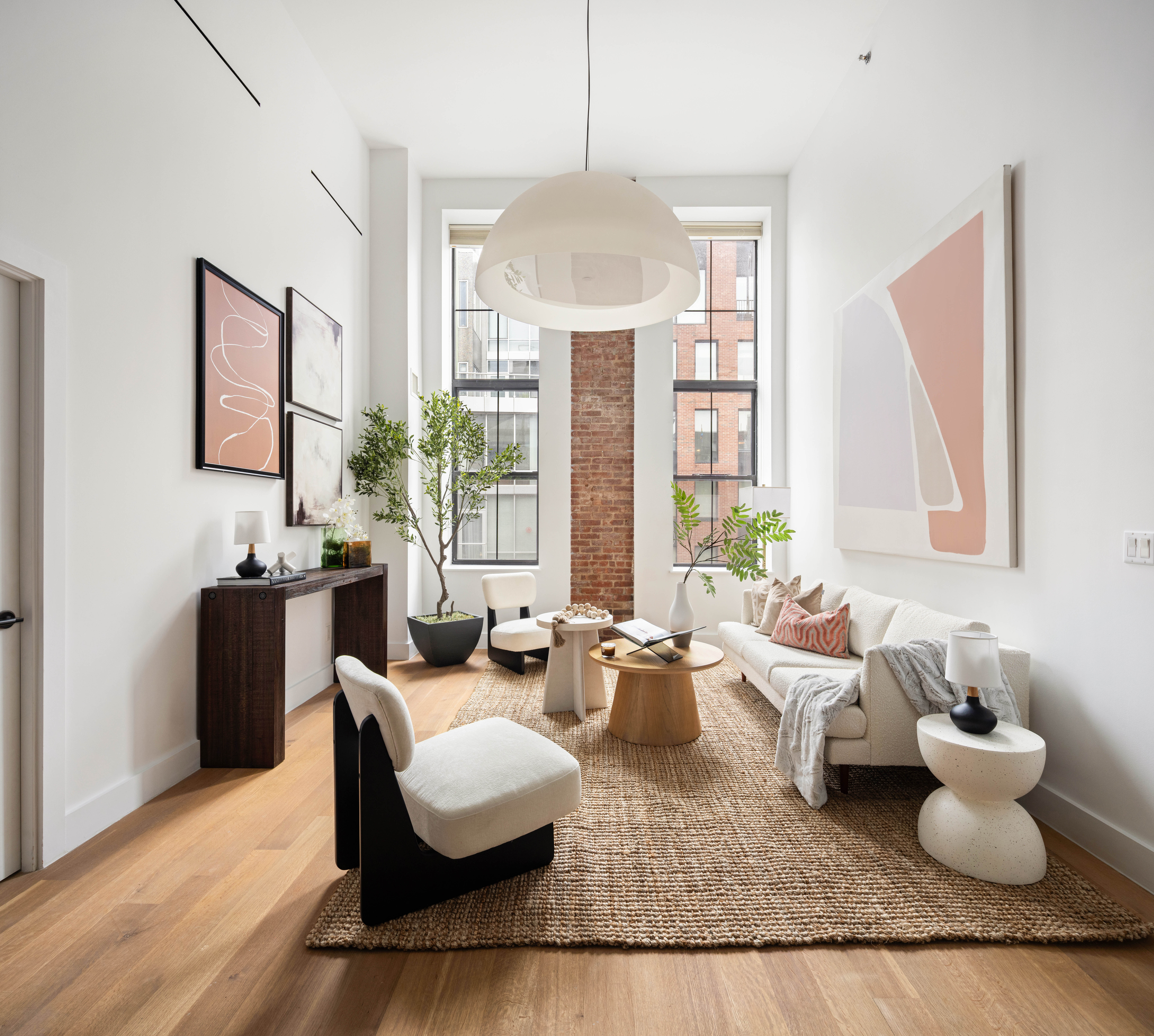 a living room with fireplace furniture and a large window