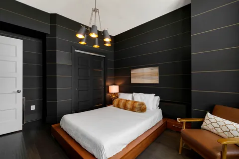 a bedroom with a bed and a chair
