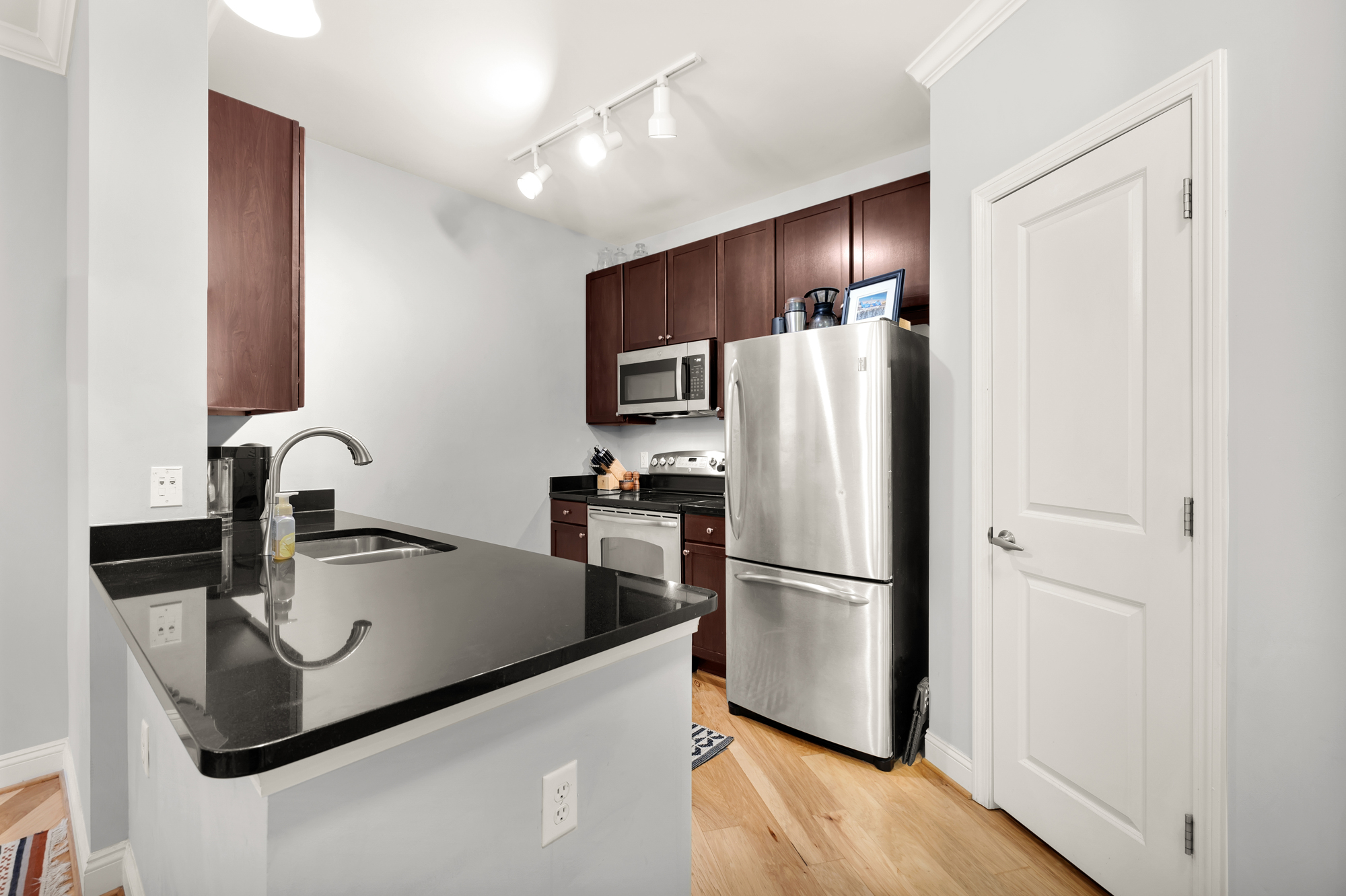 1391 Pennsylvania Ave. Southeast, Unit 324 Washington, DC 20003 - Photo 5 of 33 a kitchen with metallic refrigerator and a sink
