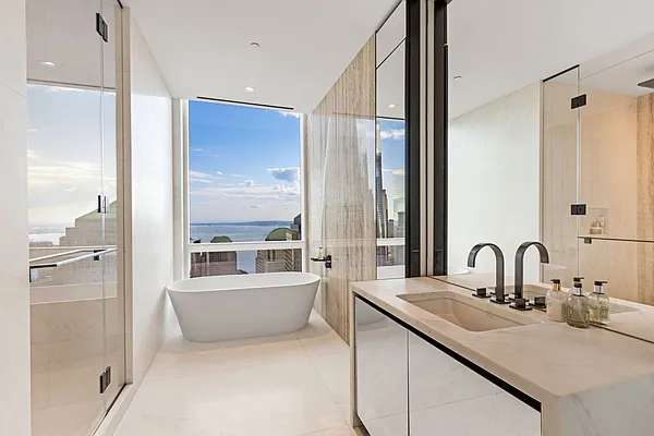 111 Murray Street, Unit 44W Manhattan, NY 10007 - Photo 2 of 17 a bathroom with a double vanity sink a mirror and a bathtub