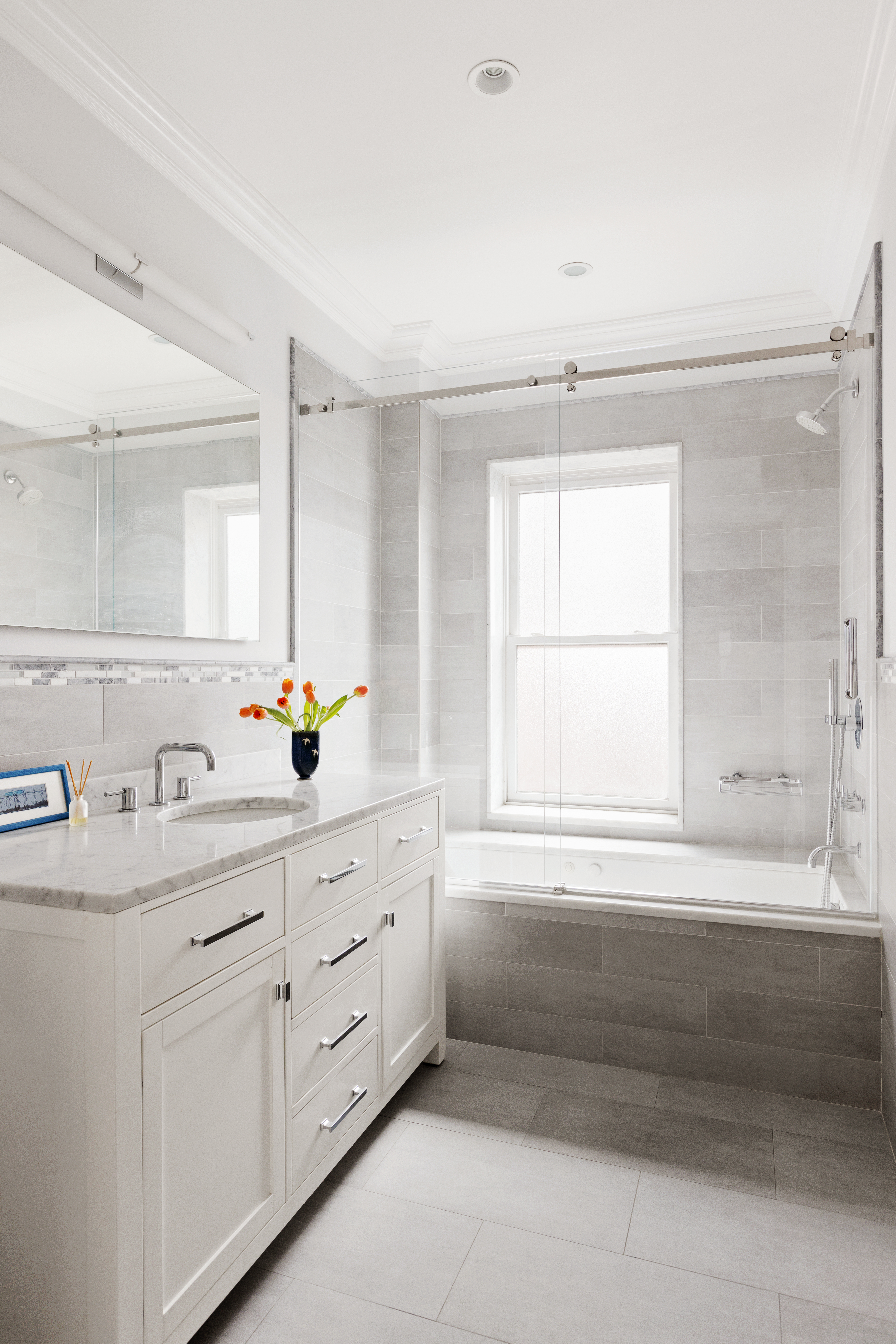 196 Berkeley Place Brooklyn, NY 11217 - Photo 17 of 25 a bathroom with a double vanity sink a bathtub and a window
