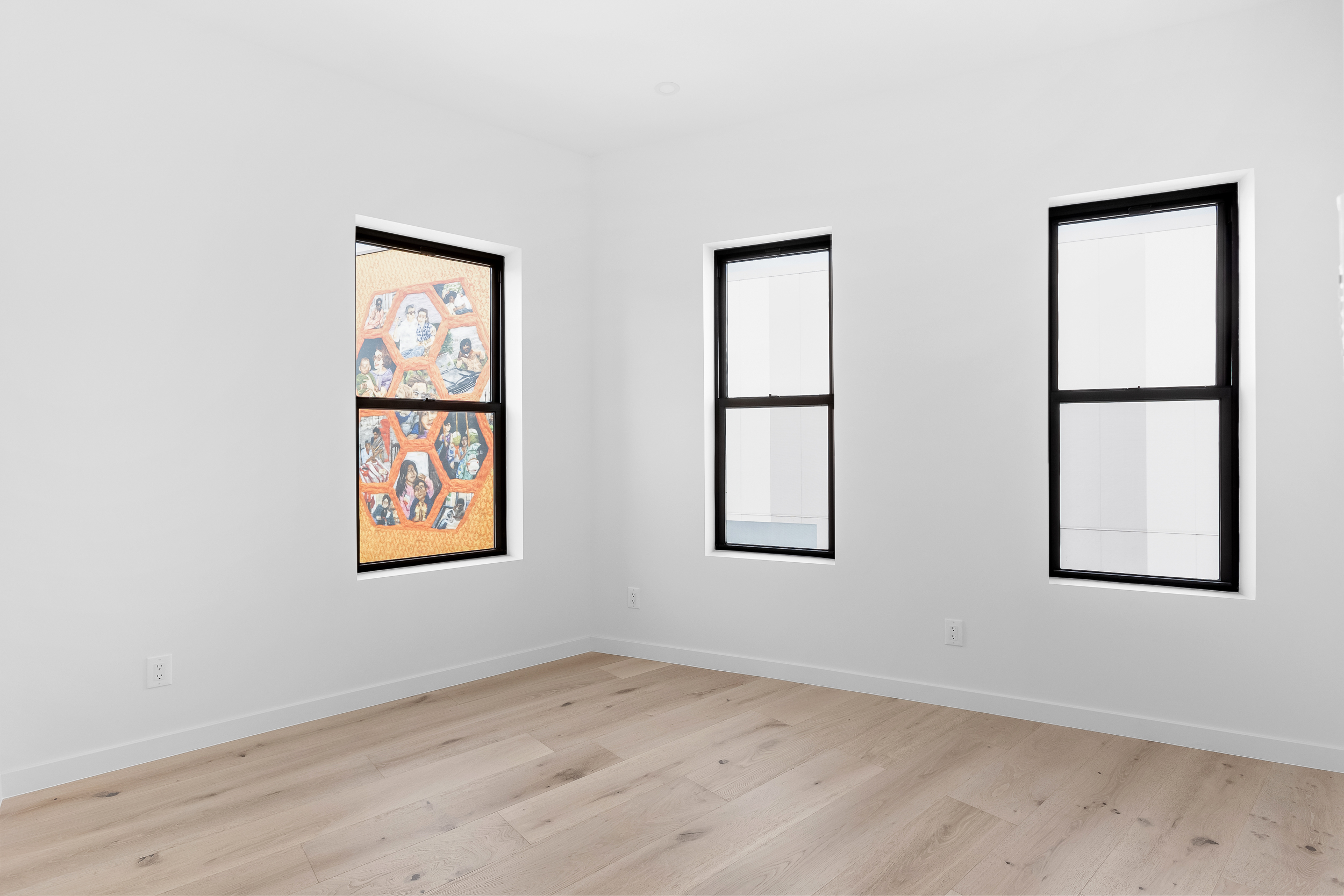 92 Jefferson Street, Unit 4 Brooklyn, NY 11206 - Photo 5 of 9 an empty room with windows and painting on the wall