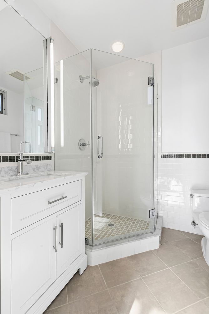 a bathroom with a shower and a sink