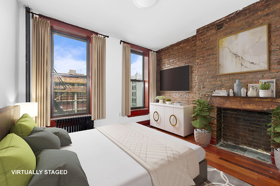 279 East Houston Street, Unit 2B Manhattan, NY 10002 - Photo 1 of 4 a bedroom with a bed and a television