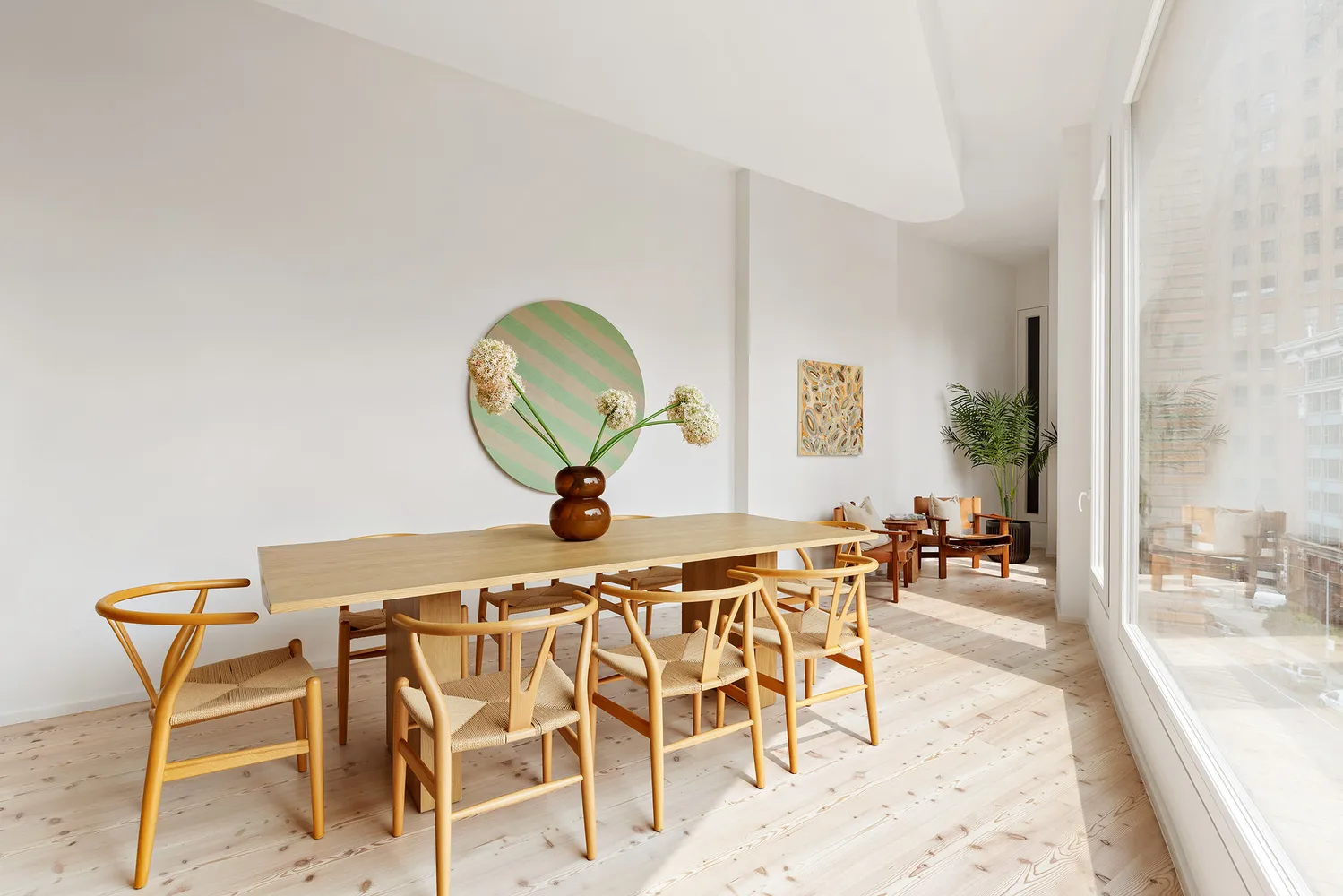 a view of a dining room with furniture and a mirror