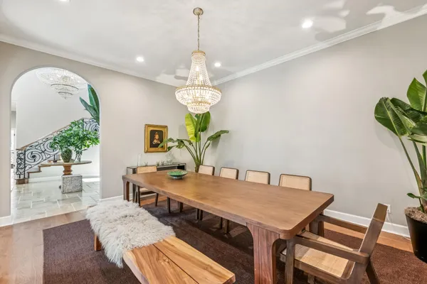 a view of a dining room with furniture and chandelier
