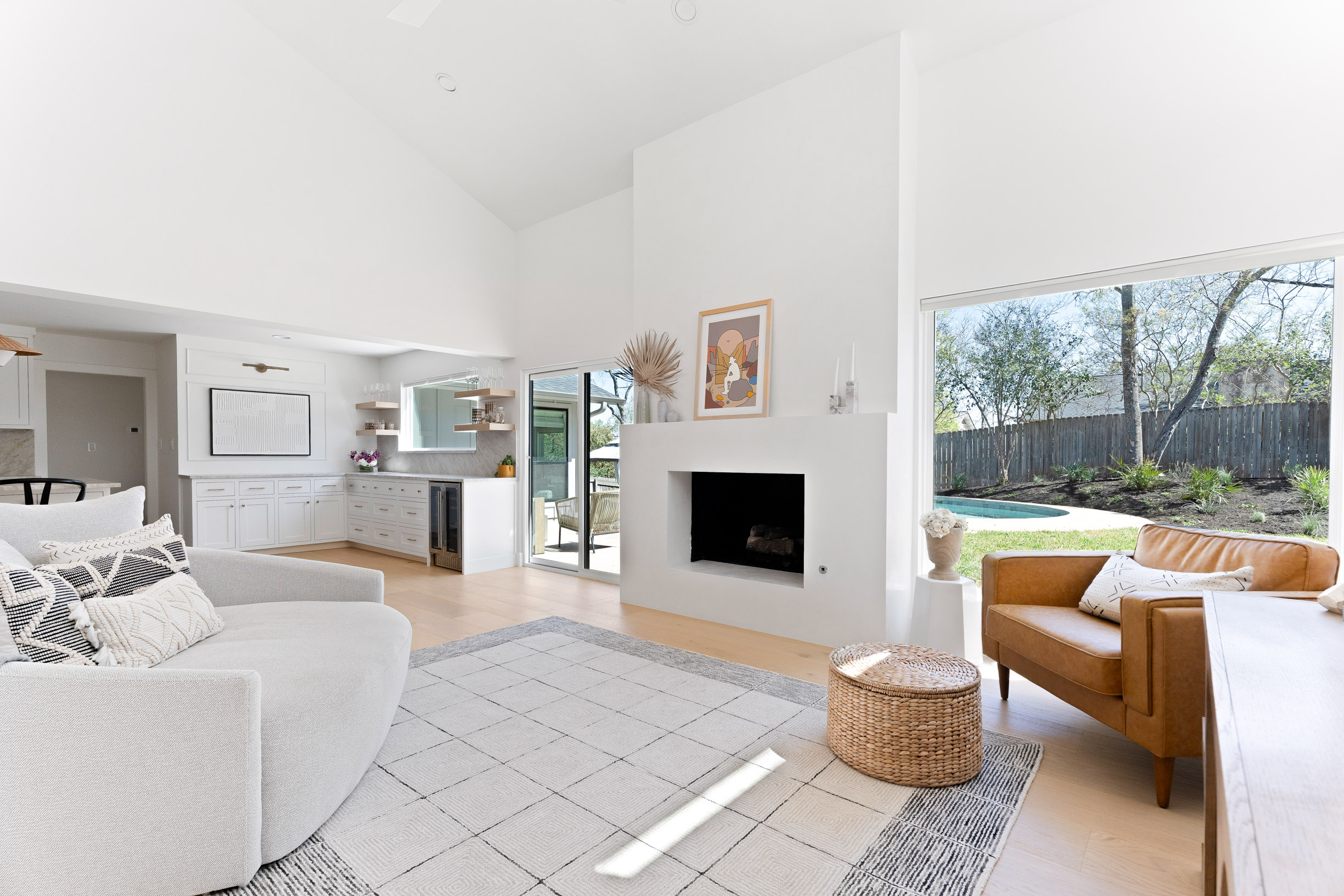 1317 Thaddeus Cove Austin, TX 78746 - Photo 6 of 22 a living room with furniture a rug and a fireplace