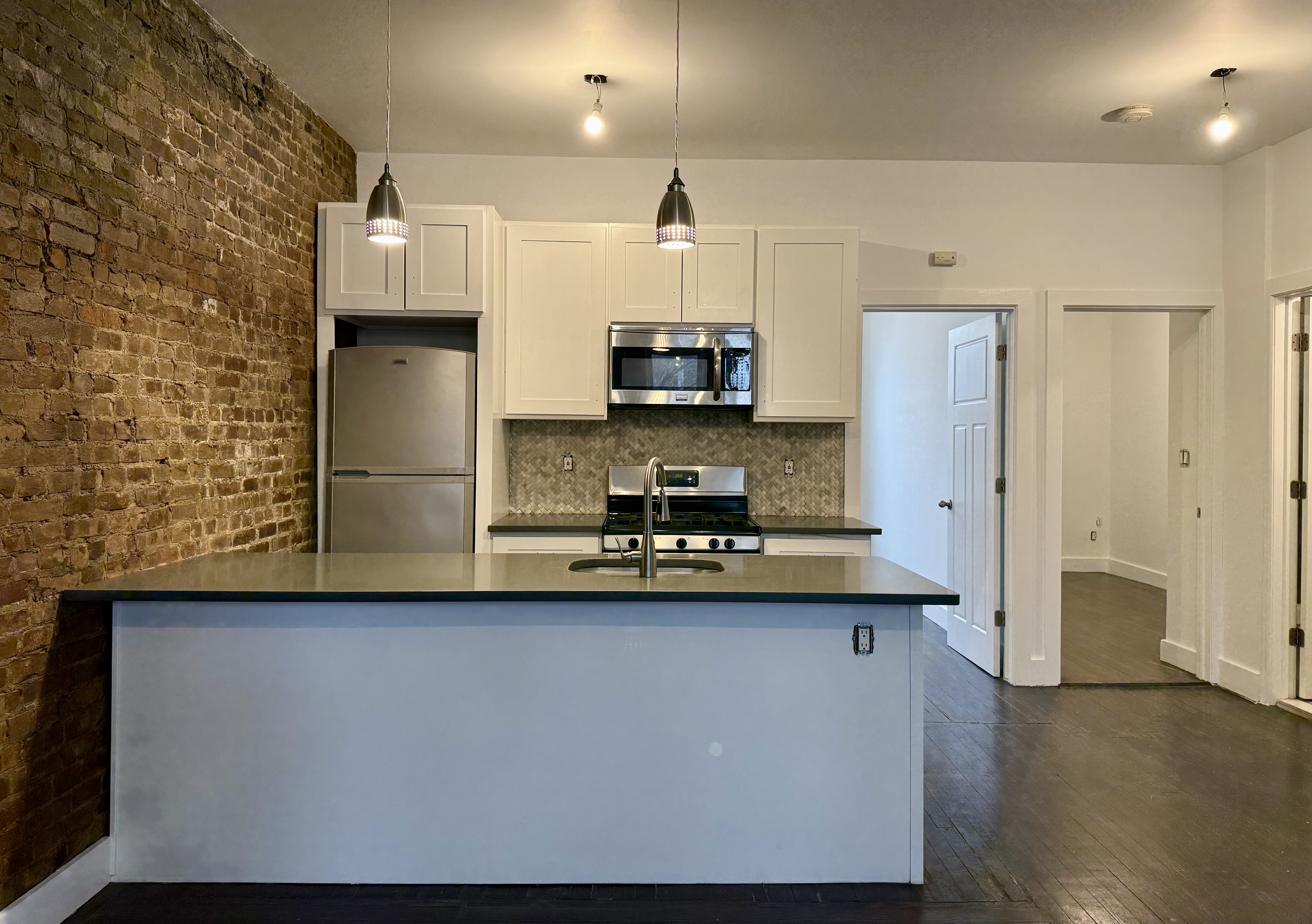 249 94th Street, Unit 1 Brooklyn, NY 11209 - Photo 3 of 13 a kitchen with stainless steel appliances a sink stove and refrigerator