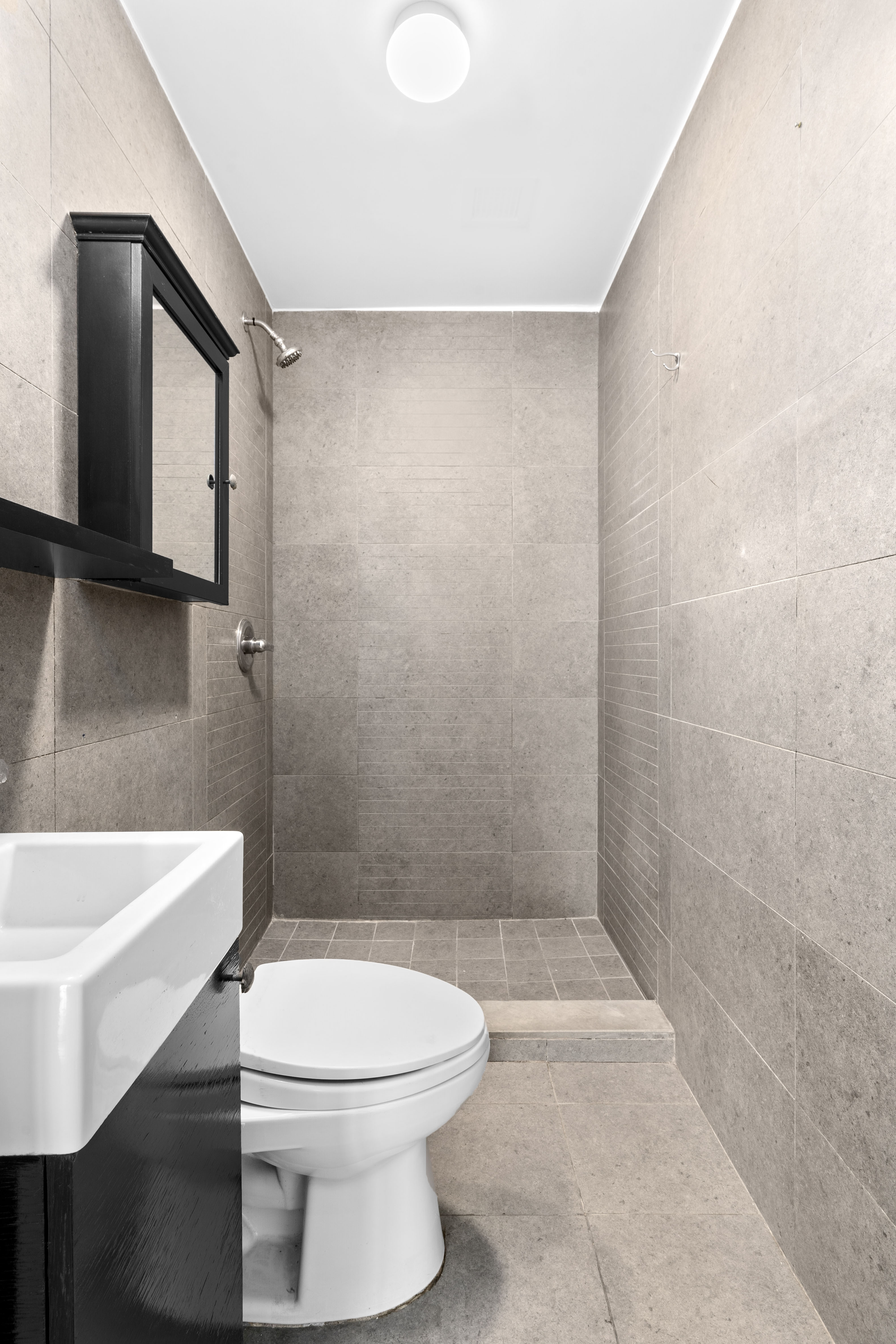 269 8th Street, Unit 2R Brooklyn, NY 11215 - Photo 11 of 14 a bathroom with a toilet a sink and bathtub