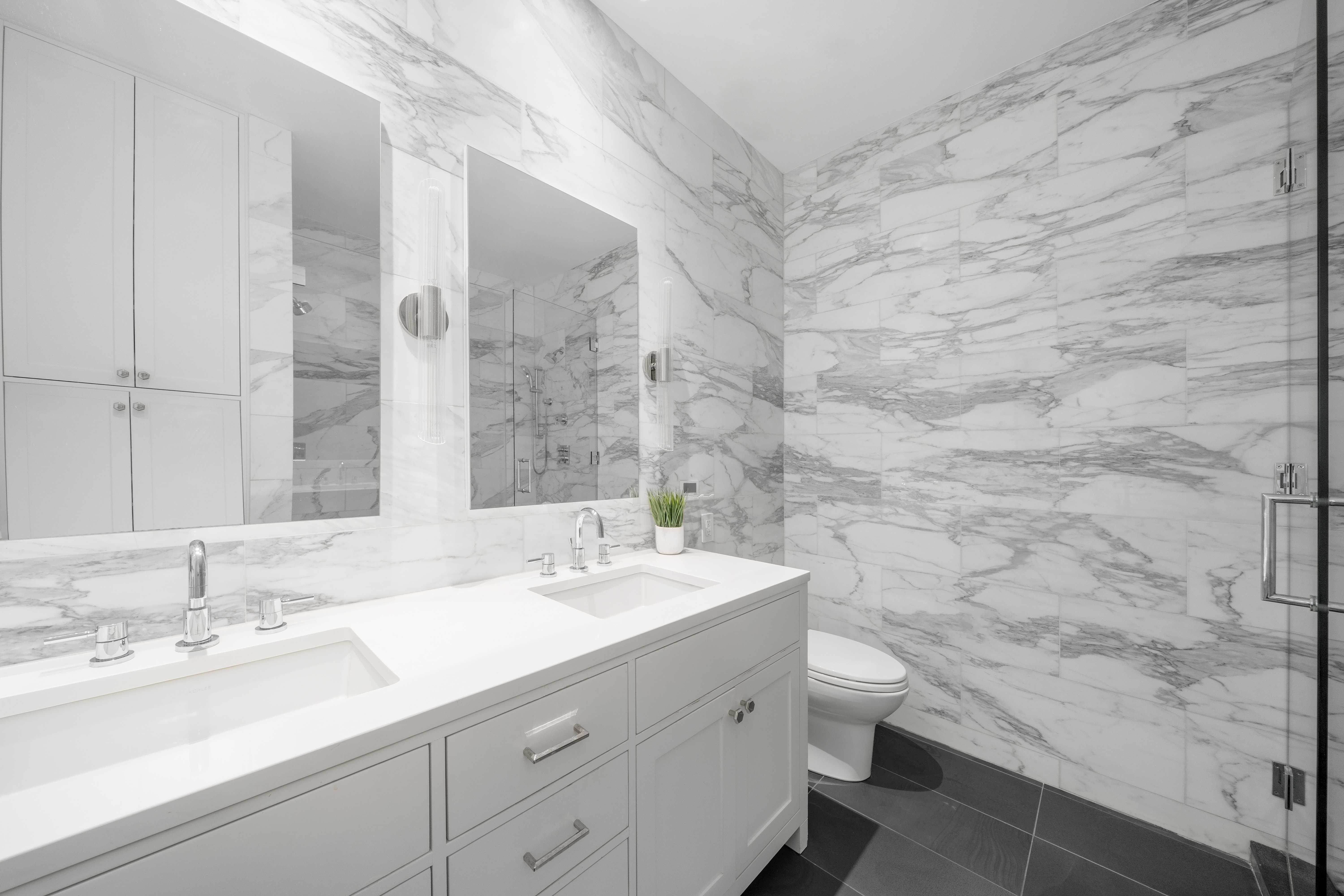 59 John Street, Unit 7D Manhattan, NY 10038 - Photo 6 of 10 a bathroom with a sink a toilet and a mirror