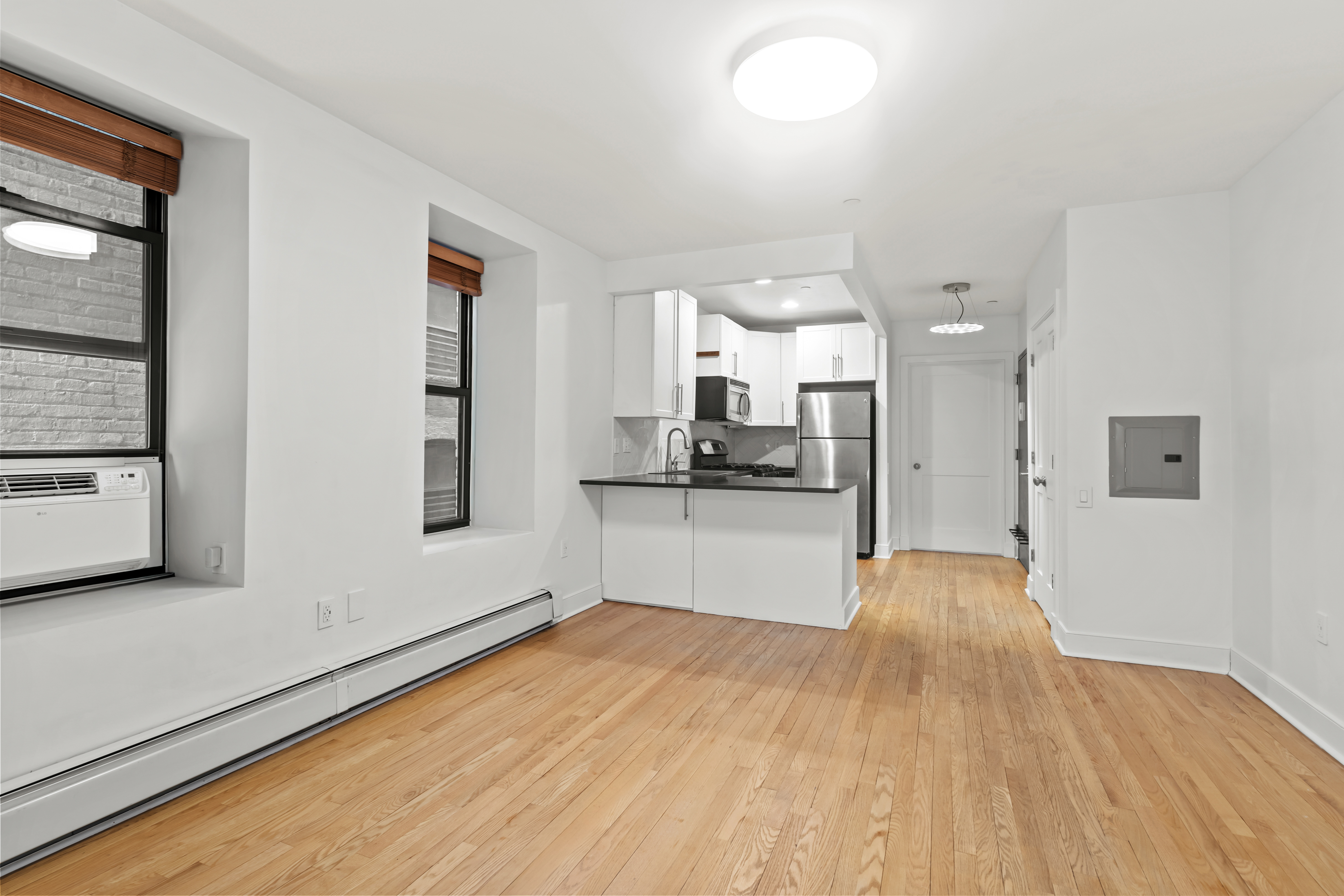 305 West 150th Street, Unit 206 Manhattan, NY 10039 - Photo 3 of 18 a view of a kitchen with a sink and a refrigerator