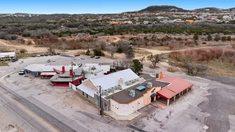 an aerial view of a houses with a mountain