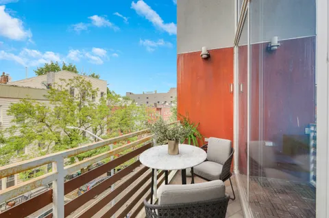 a balcony with table and chairs