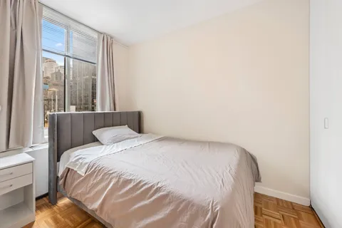 a bedroom with a bed and a window