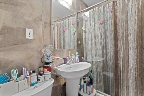 a bathroom with a sink a toilet and shower curtain