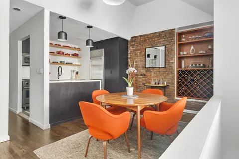 a dining room with furniture and wooden floor