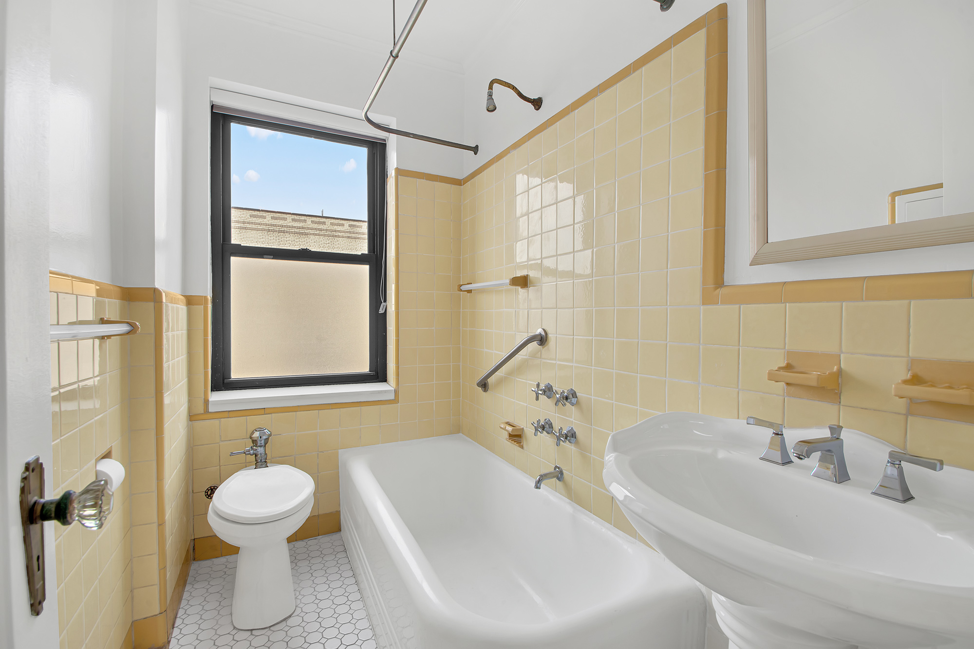 200 Pinehurst Avenue, Unit 5C Manhattan, NY 10033 - Photo 10 of 17 a bathroom with a sink toilet and shower