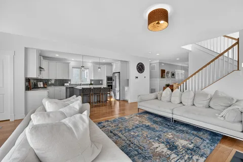 a living room with furniture kitchen view and a table