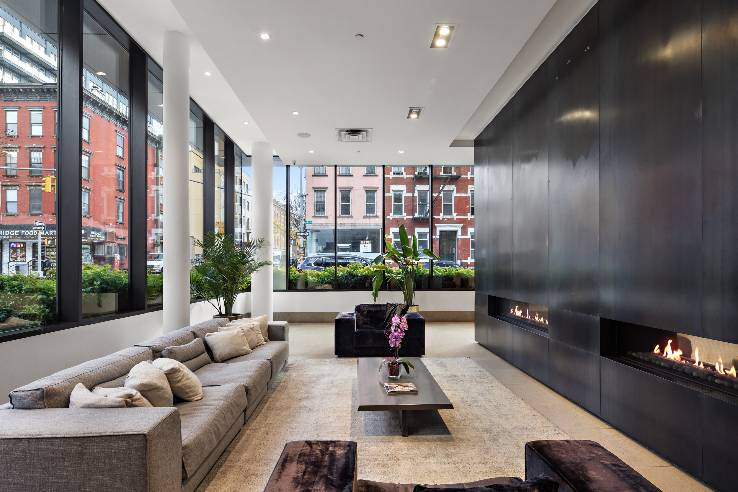 429 Kent Avenue, Unit TH2 Brooklyn, NY 11249 - Photo 31 of 34 a living room with furniture and a floor to ceiling window