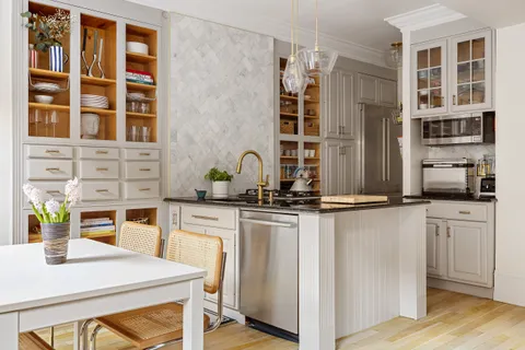 a kitchen with stainless steel appliances a sink and cabinets