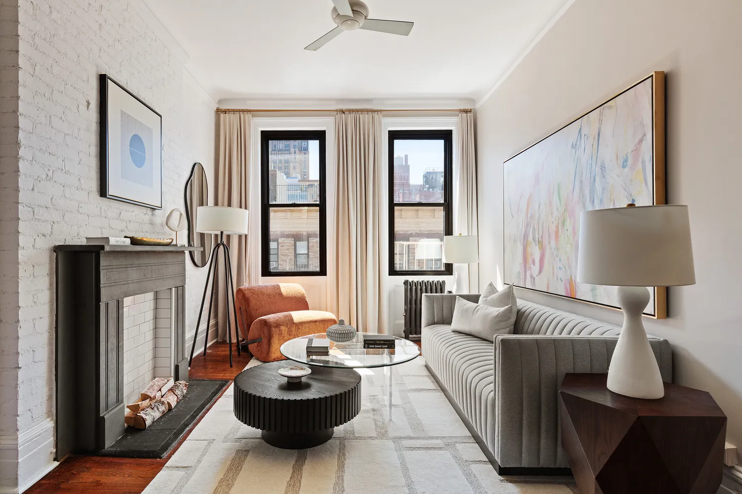 a living room with furniture and a lamp