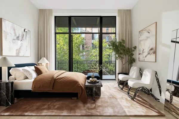 a spacious bedroom with a bed and large window