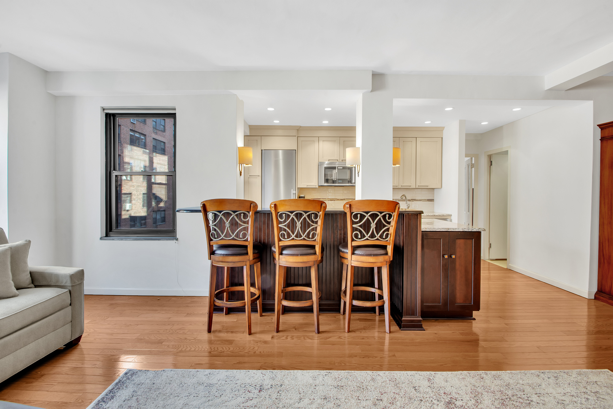 2 Tudor City Place, Unit 7FS Manhattan, NY 10017 - Photo 3 of 9 a view of a dining room with furniture and wooden floor