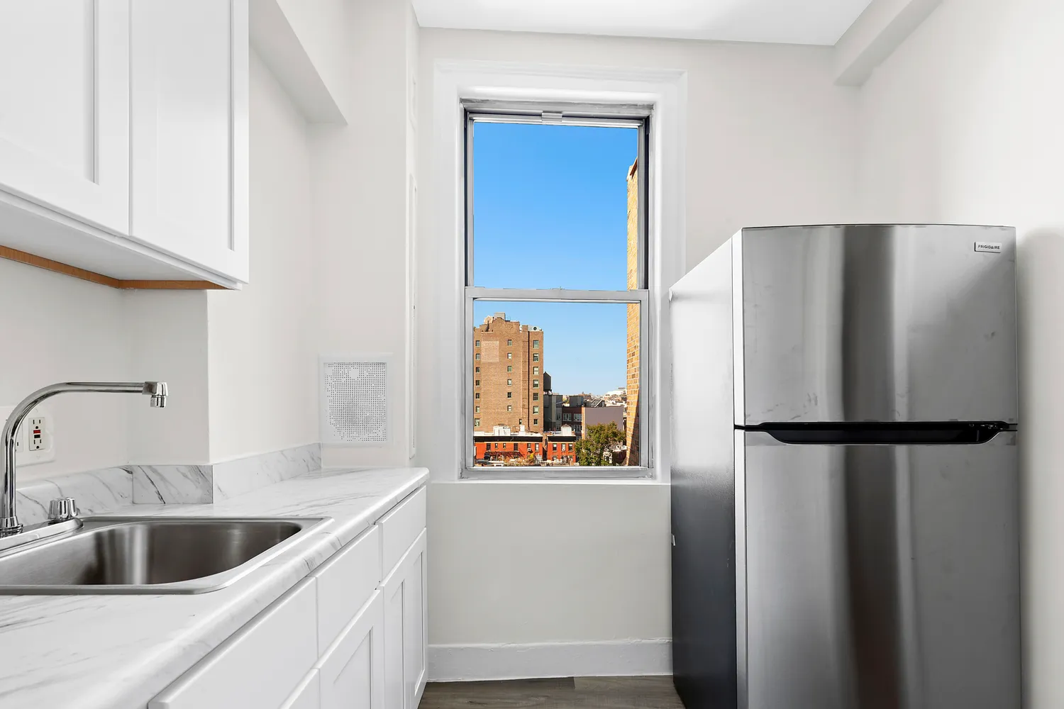 a kitchen with refrigerator and cabinets