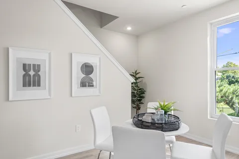 a bedroom with a bed and painting on the wall