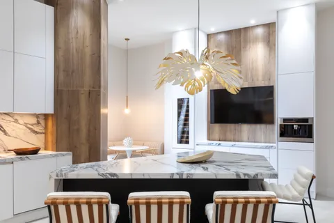 a kitchen with a table chairs refrigerator and microwave