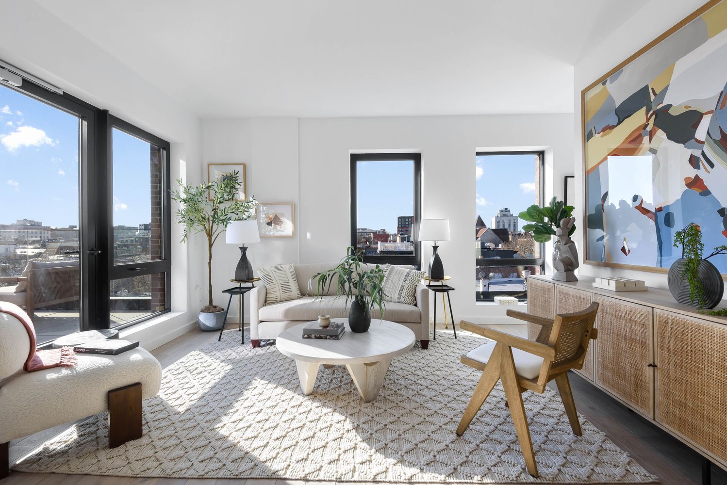 a living room with furniture and a potted plant