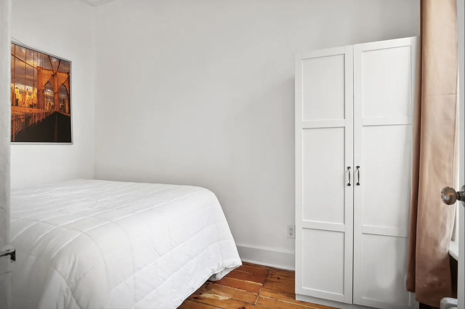 397 Clermont Avenue, Unit 3R Brooklyn, NY 11238 - Photo 3 of 8 a bedroom with a bed and wooden floor