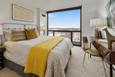 a bed sitting in a bedroom next to a window