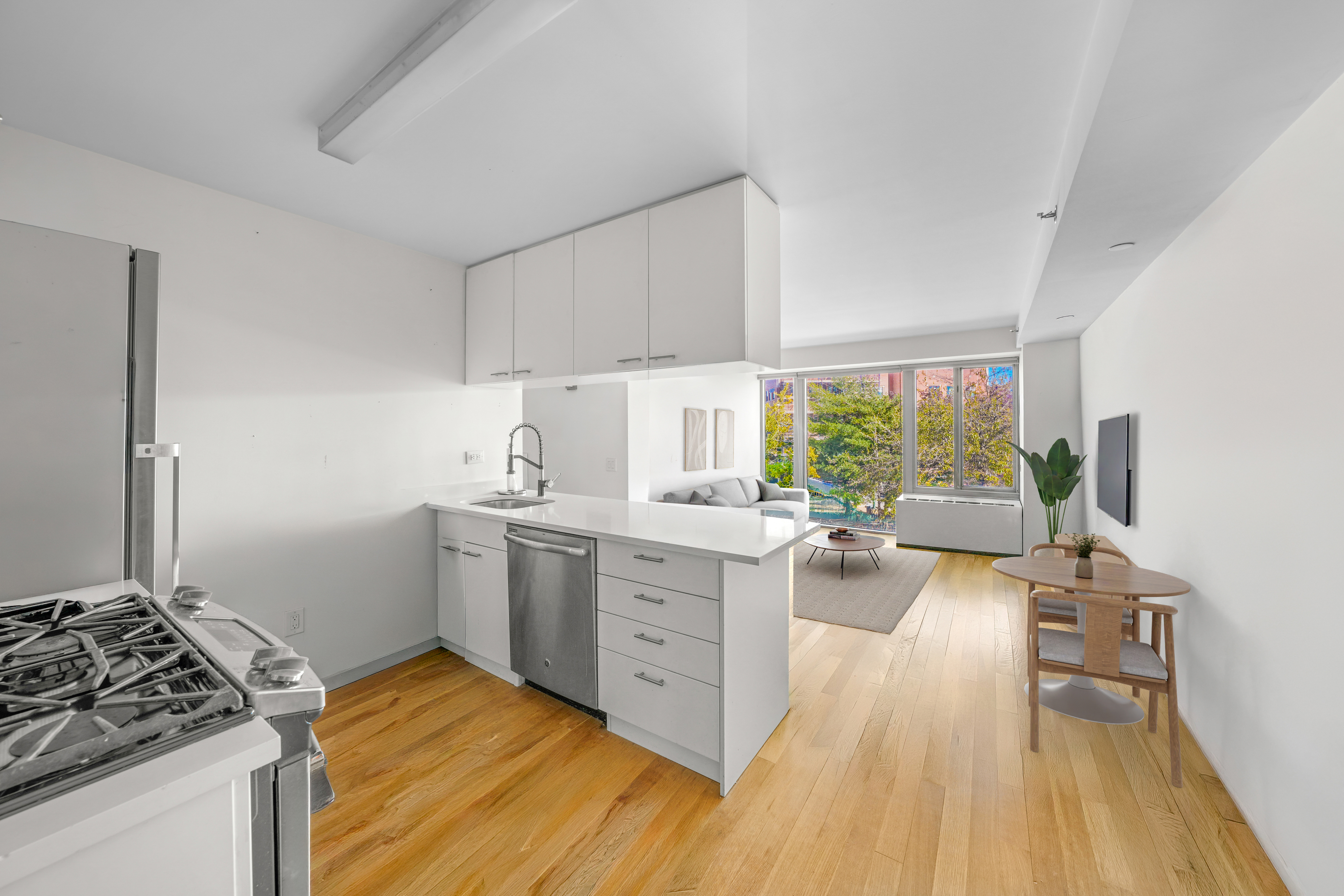 448 West 167th Street, Unit 3E Manhattan, NY 10032 - Photo 7 of 24 a kitchen with sink cabinets and wooden floor