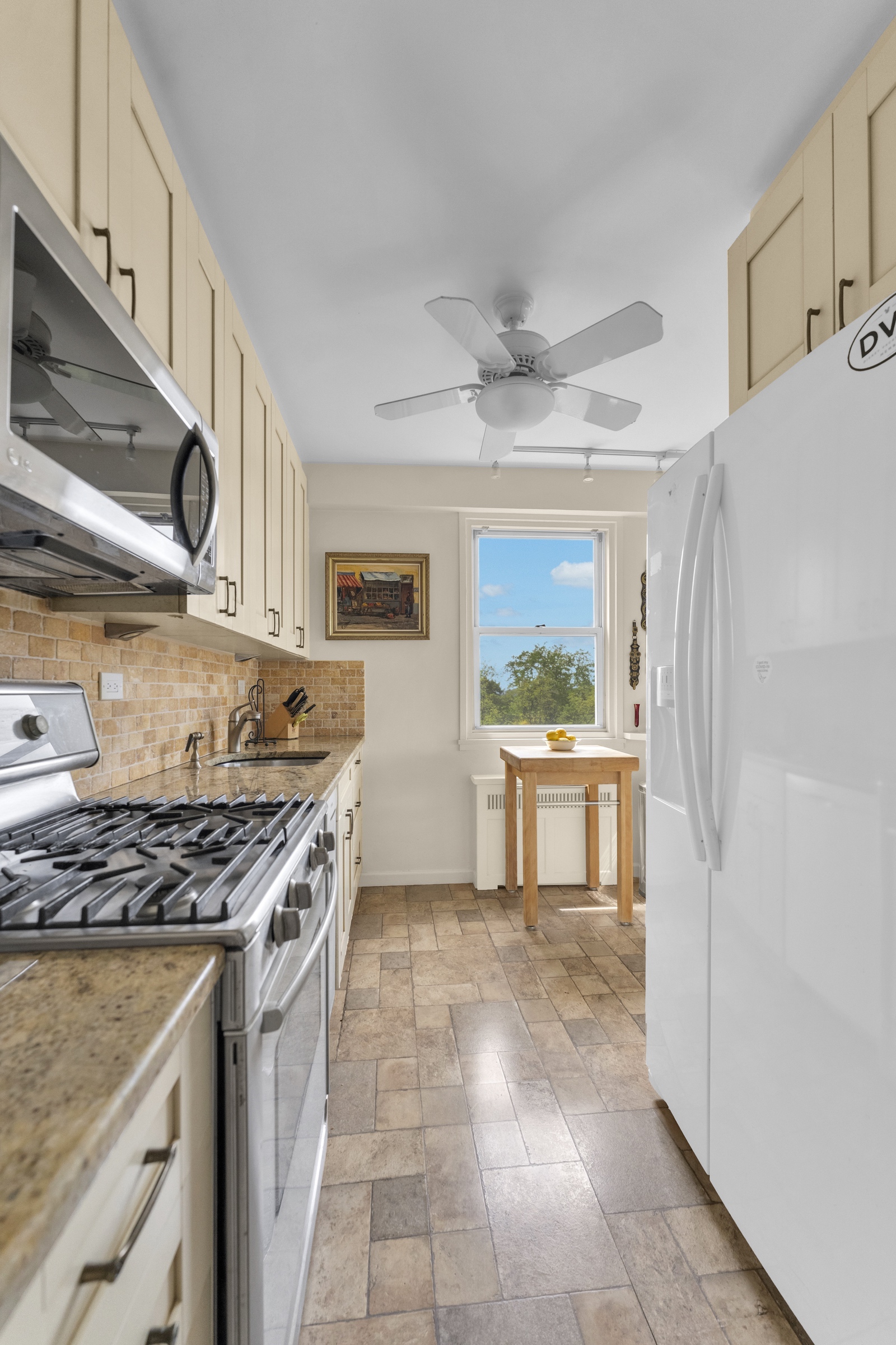 2621 Palisade Avenue, Unit 11J Bronx, NY 10463 - Photo 10 of 19 a kitchen with stainless steel appliances granite countertop a stove a sink and a refrigerator