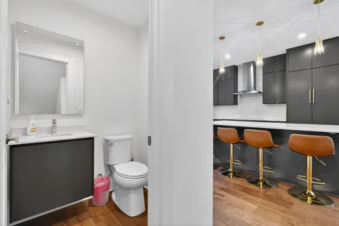 a bathroom with a toilet a sink and a mirror