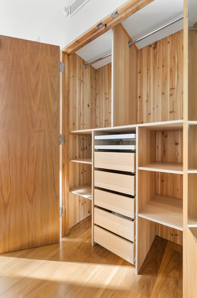 a view of walk in closet with empty racks