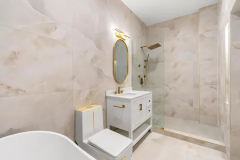 a bathroom with a sink mirror and toilet