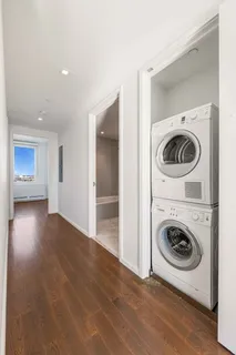 a view of a hallway with washer and dryer