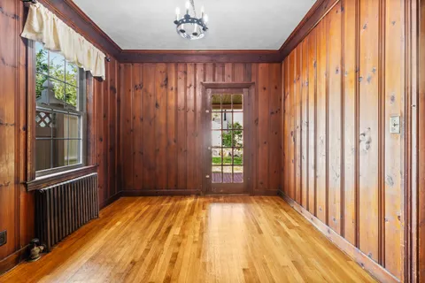 a view of a room with wooden floor and windows