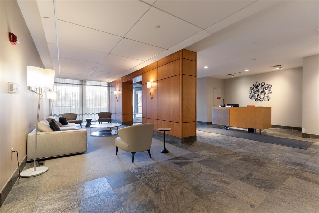 35 Channel Center Street, Unit 402 Boston, MA 02210 - Photo 31 of 35 a living room with furniture and a table