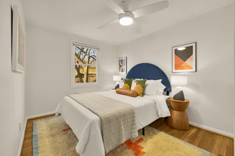 a bedroom with a bed and lamp