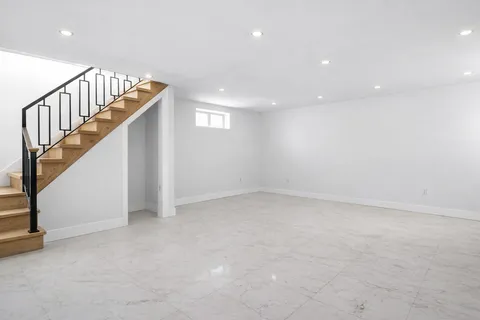 a view of an empty room with stairs