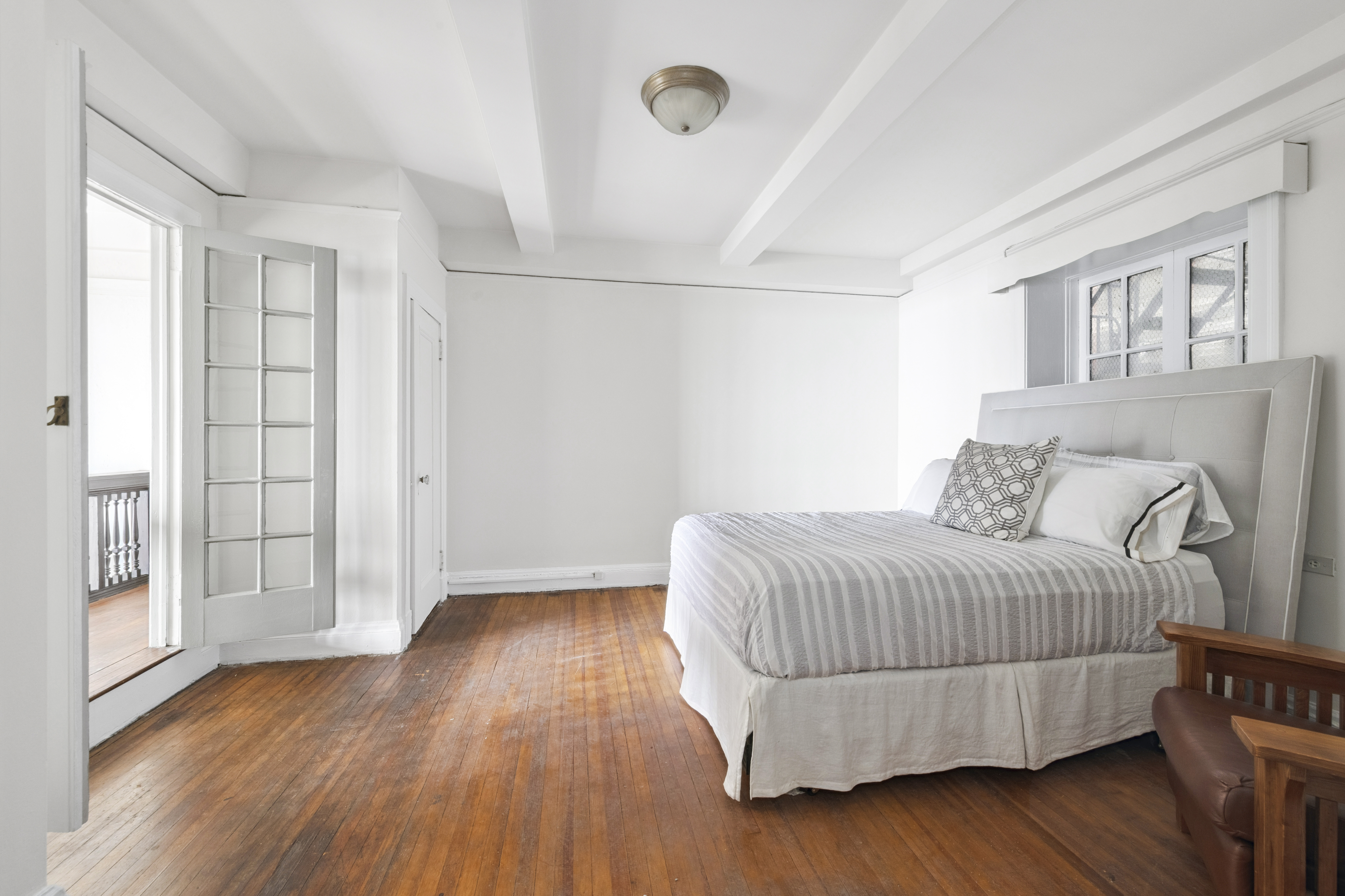 1 West 67th Street, Unit 303-304 Manhattan, NY 10023 - Photo 8 of 18 a bedroom with a bed and wooden floor