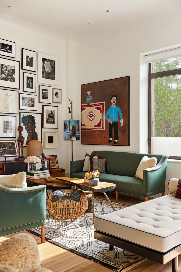 a living room with furniture and painting on the wall