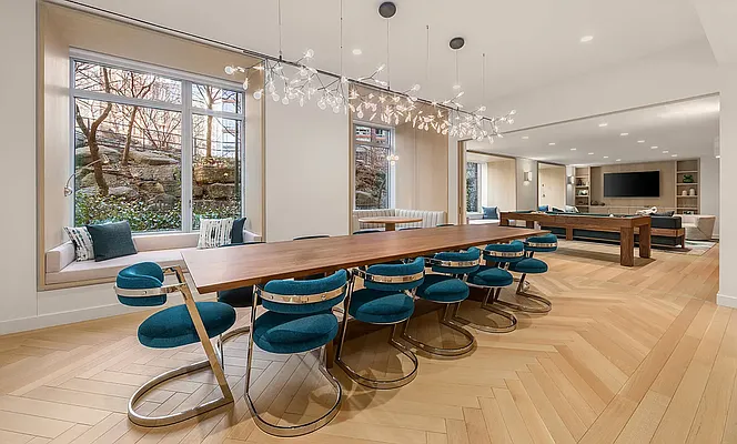 20 River Terrace, Unit 6Q Manhattan, NY 10282 - Photo 13 of 20 a room with furniture and a large window