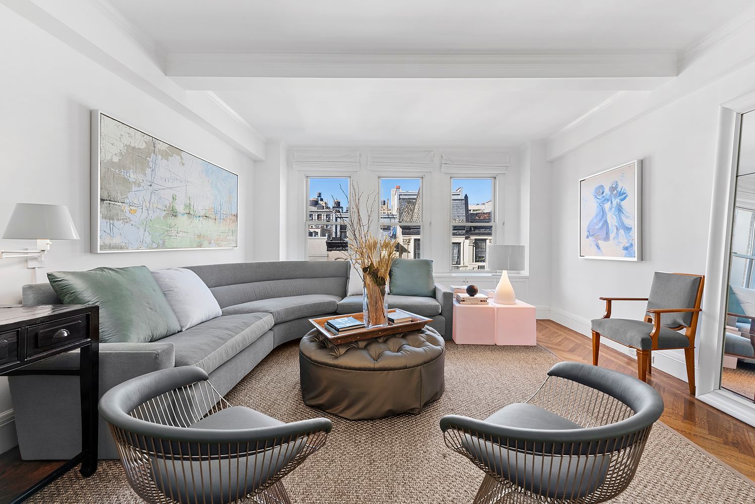 a living room with furniture and a potted plant