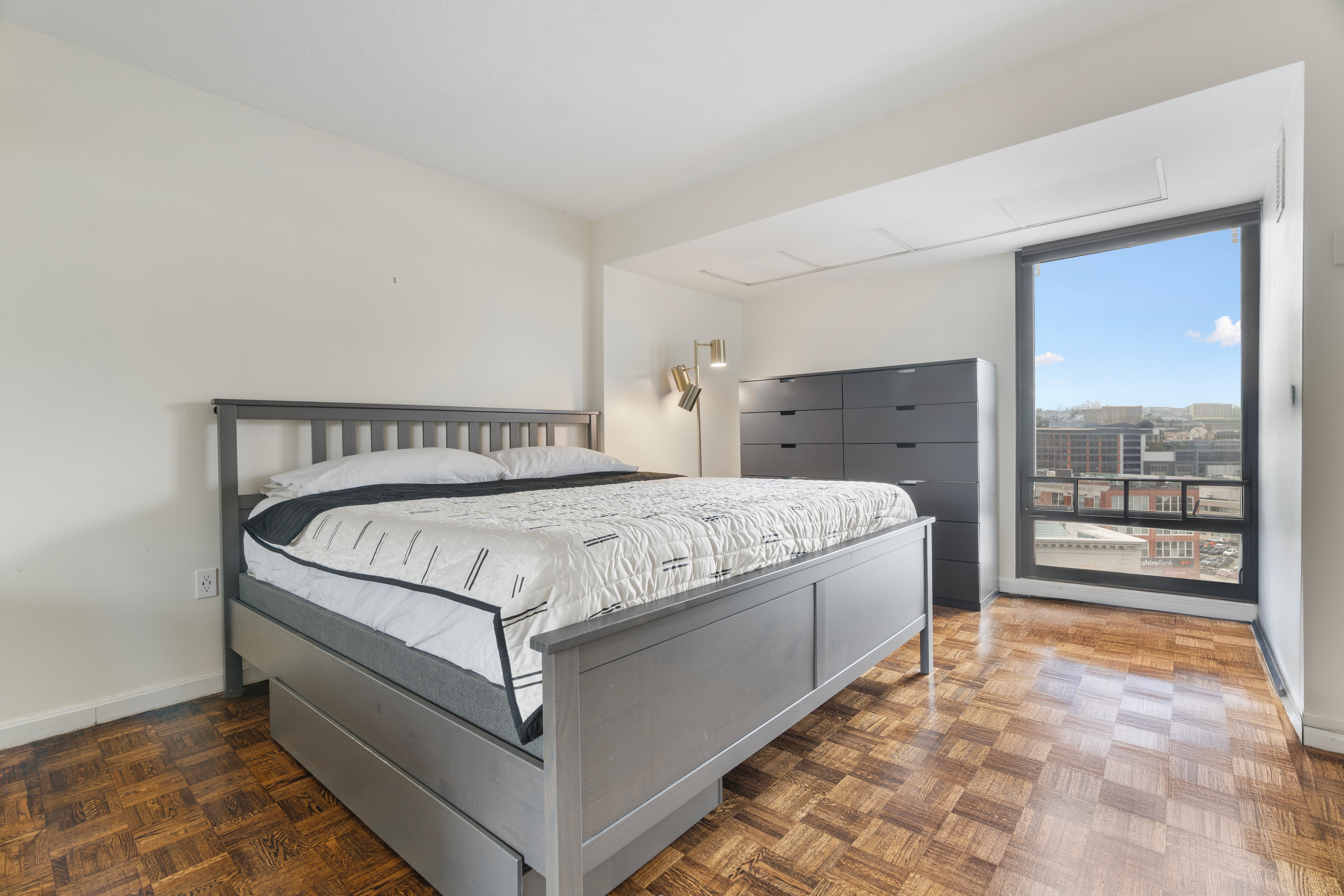 566 Commonwealth Avenue, Unit 1100 Boston, MA 02215 - Photo 6 of 13 a bed sitting in a spacious bedroom next to a window